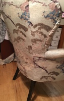 Back view of upholstered armchair with Asian inspired fabric