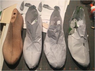 Three paper test shoes lined up